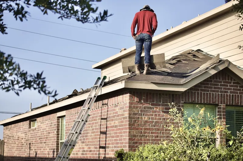 Professional roofer working on a residential roof in Fort McNair